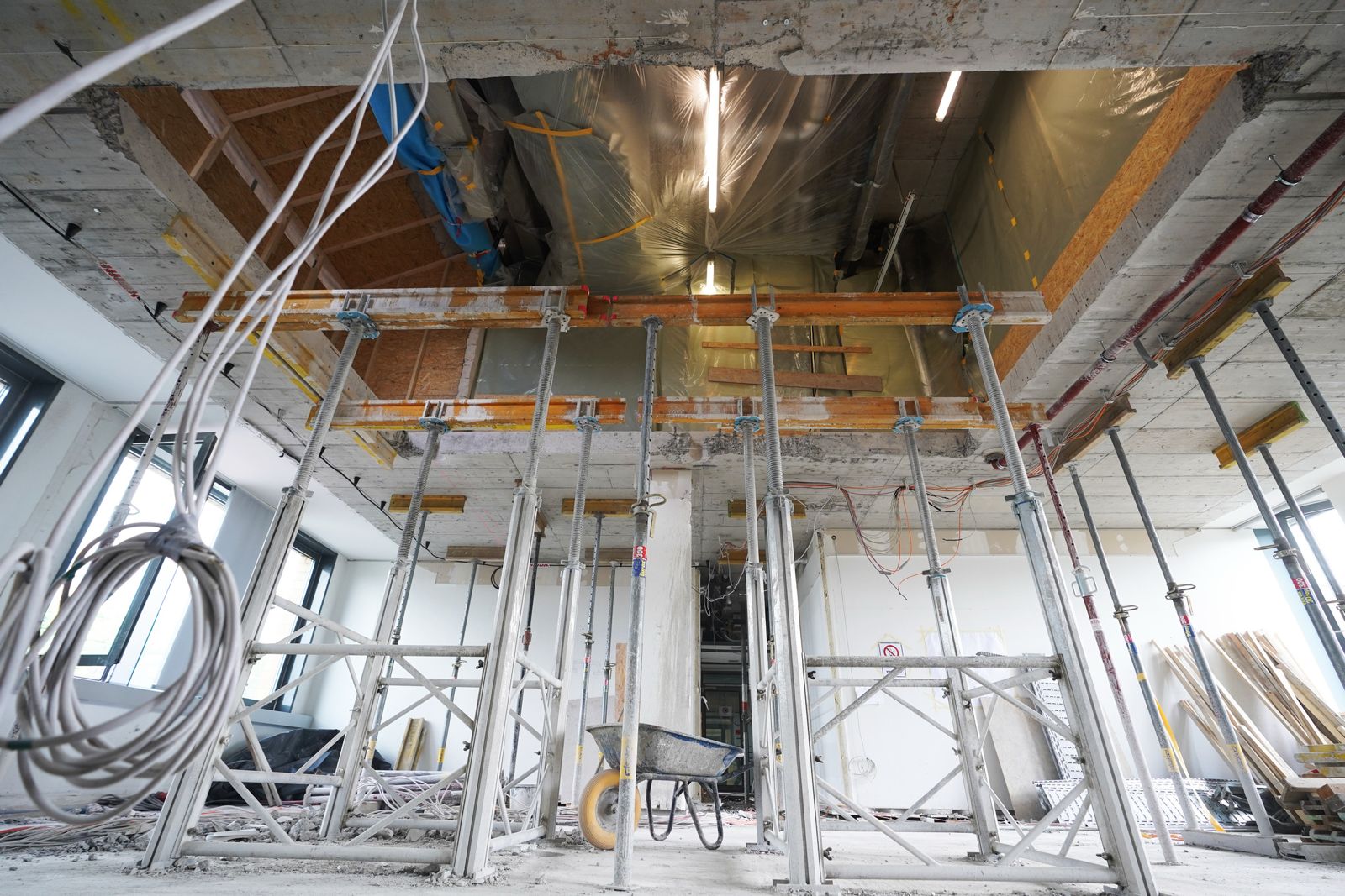Baustützen sichern eine rechteckige Deckenöffnung in einer Stahlbetondecke